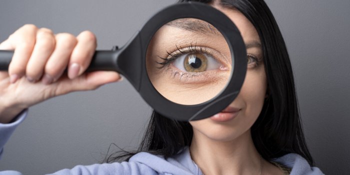 woman looking through a magnifying glass, searching for a finding concept funny humor image
