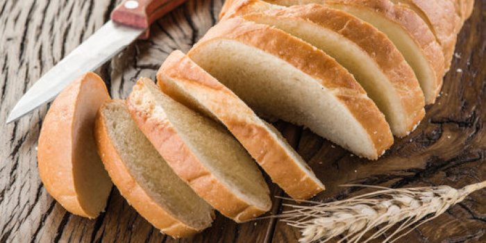 sliced white bread on the old wooden plank