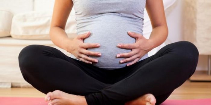 gros plan, de, femme enceinte, sÃ©ance, jambes croisÃ©es, sur, exerciseur