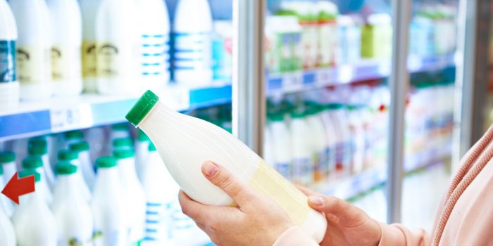 woman shopping milk in grocery store