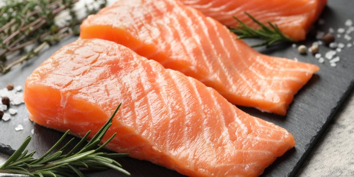 fresh raw salmon and ingredients for marinade on light grey table, closeup