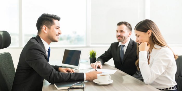 smiling accountant discussing plan with colleagues in office