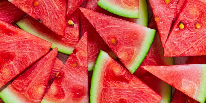 macro sliced watermelon,red watermelon triangular piece on white blackground