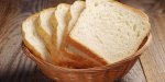 toast bread in wicker basket on old wooden table