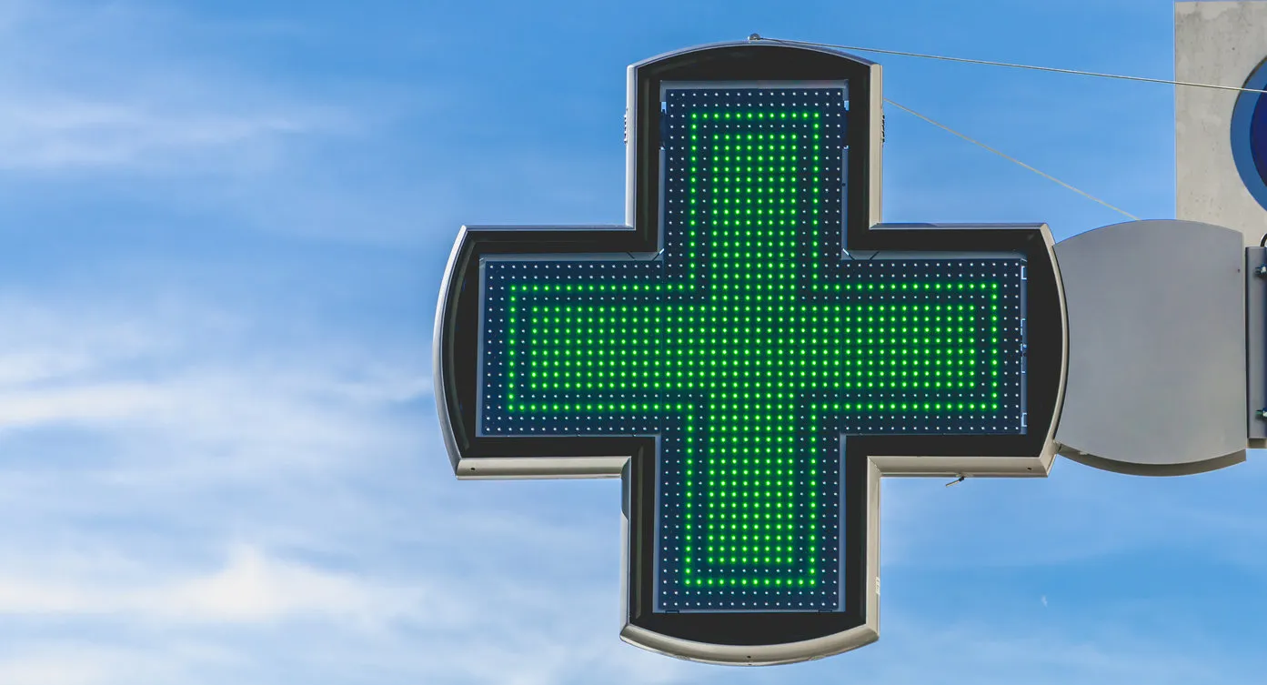 green cross of pharmacy electronics on blue sky green cross of pharmacy electronics on blue sky