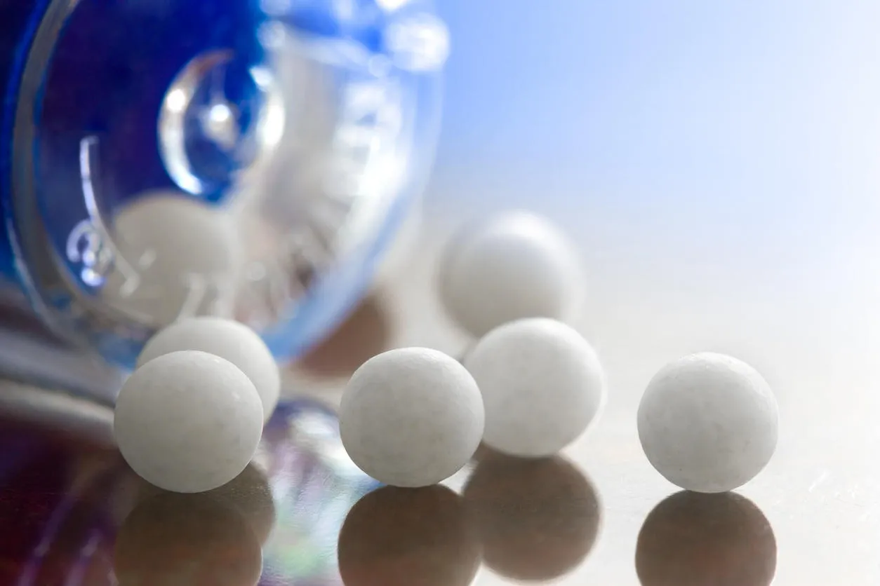 extreme macro of homeopathic medications - small white balls and the container extreme macro of homeopathic medications - small white balls and the container