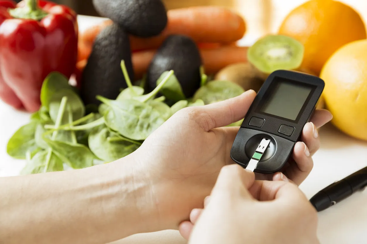 diabetes monitor, diet and healthy food eating nutritional concept with clean fruits and vegetables with diabetic measuring tool kit diabetes monitor, diet and healthy food eating nutritional concept with clean fruits and vegetables with diabetic measuring tool kit