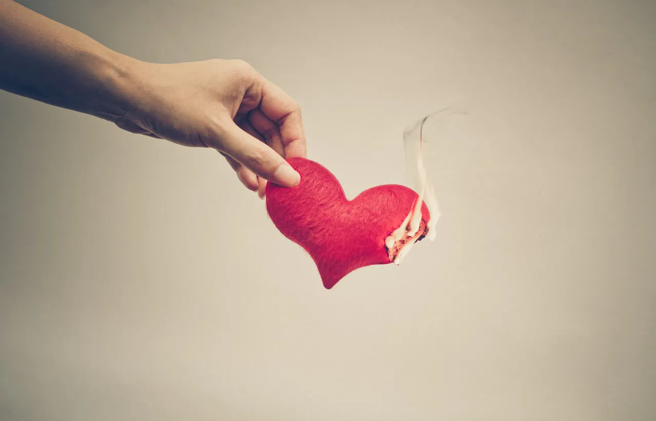 female hand giving a heart on fire   dangerous love
