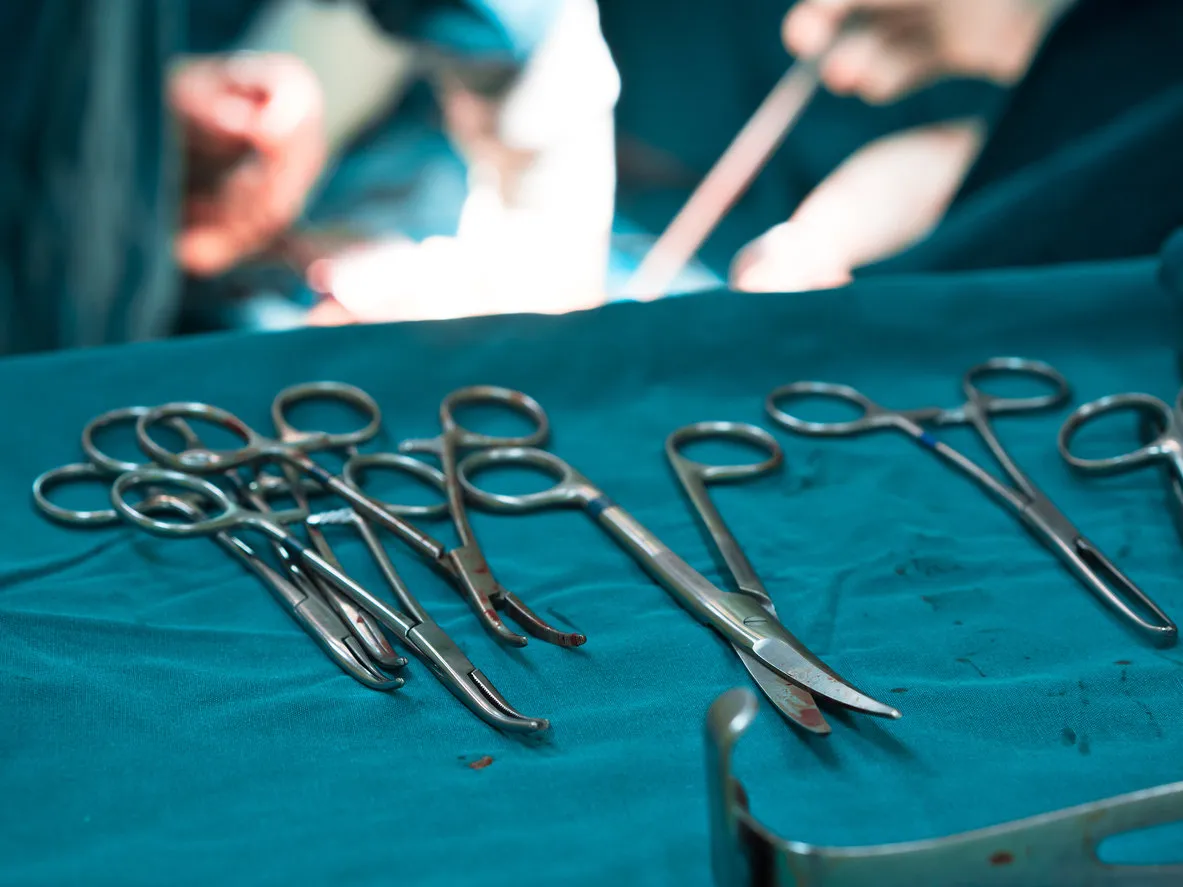 sterile surgical tools or instruments on surgical tray with blood stain,with blur surgeon team background in operating room at hospital sterile surgical tools or instruments on surgical tray with blood stain,with blur surgeon team background in operating room at hospital