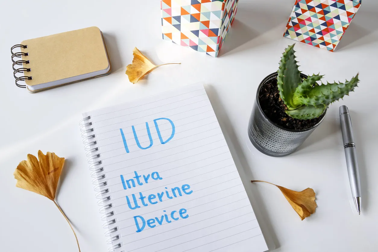 iud intra uterine device written in notebook on white table iud intra uterine device written in notebook on white table