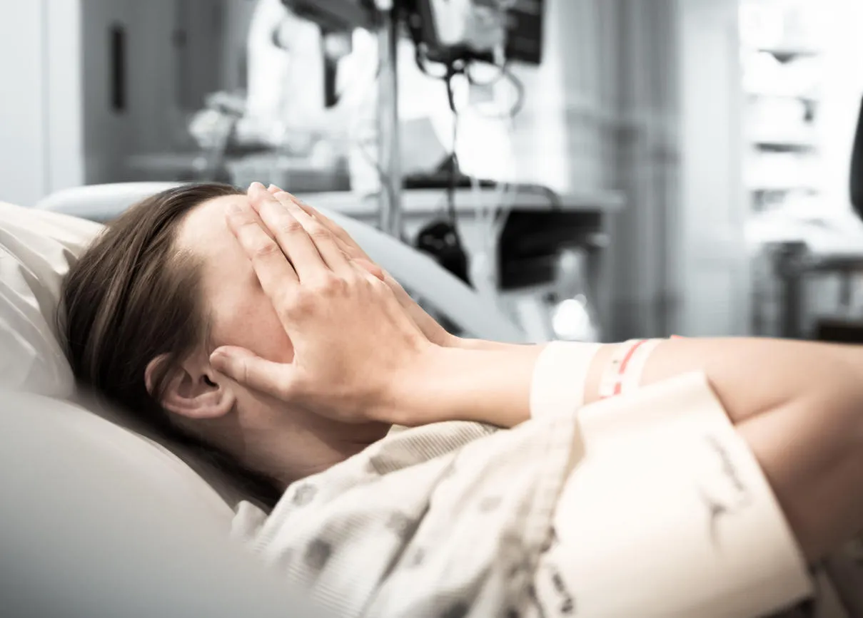 young woman patient lying at hospital bed feeling sad and depressed worried disease feeling sick in health care and clinical attention concept young woman patient lying at hospital bed feeling sad and depressed worried disease feeling sick in health care and clinical attention concept