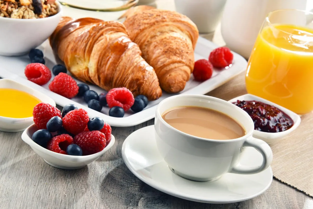 breakfast served with coffee, orange juice, croissants, cereals and fruits balanced diet breakfast served with coffee, orange juice, croissants, cereals and fruits balanced diet