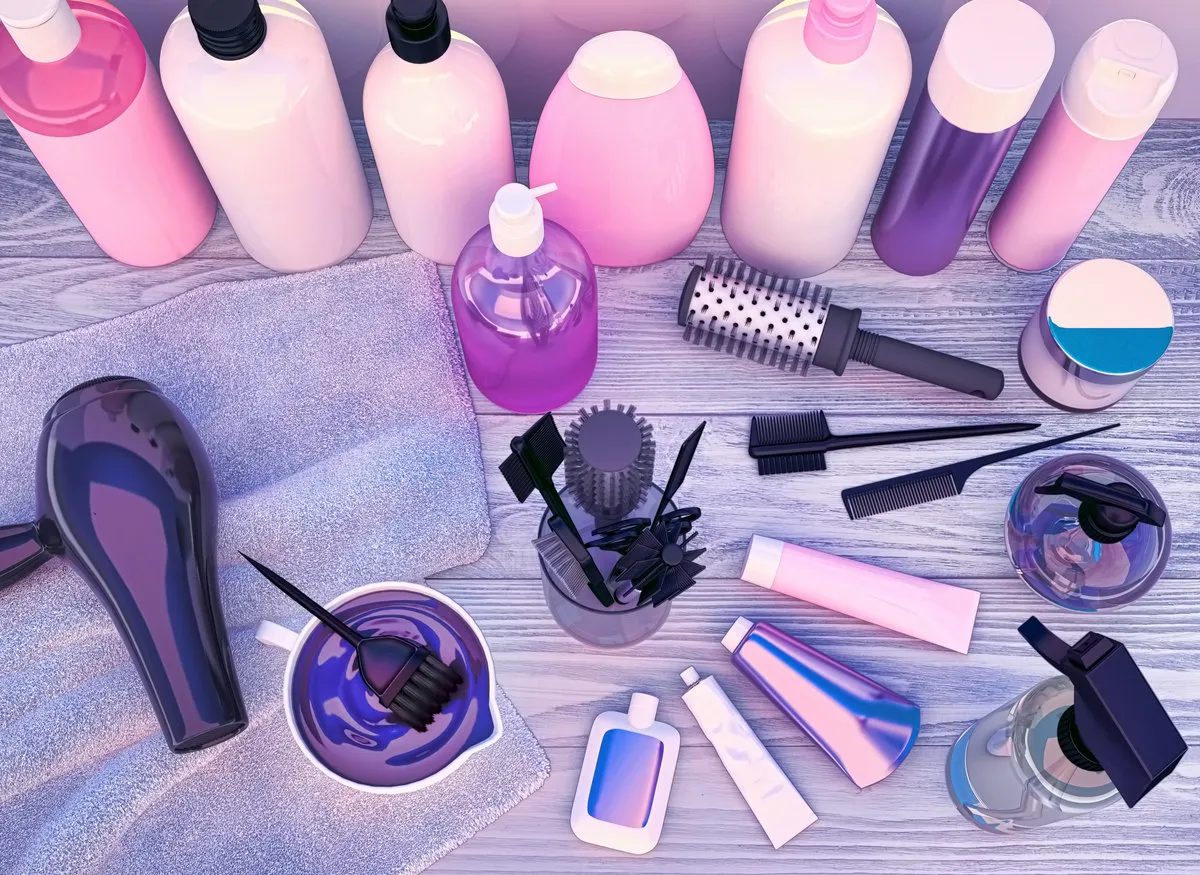 hairdryer, combs, hair dye and professional cosmetics for hair located on a wooden table hairdryer, combs, hair dye and professional cosmetics for hair located on a wooden table