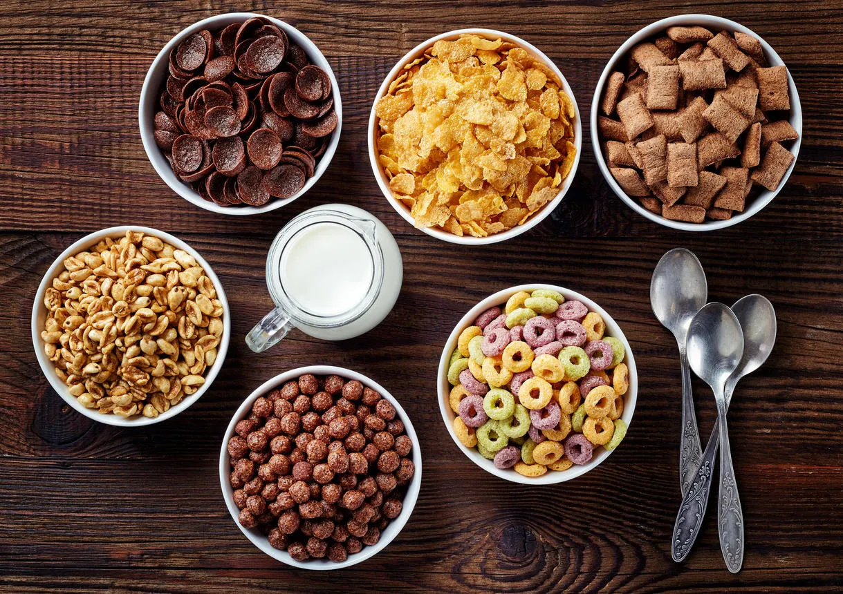 bowls of various cereals and milk from top view bowls of various cereals and milk from top view