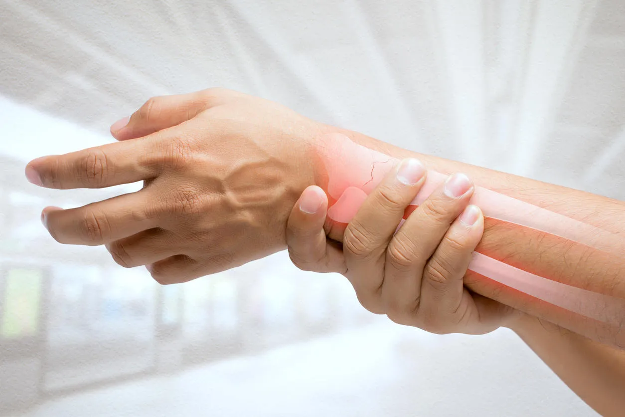 man massaging painful wrist on a white background pain concept man massaging painful wrist on a white background pain concept