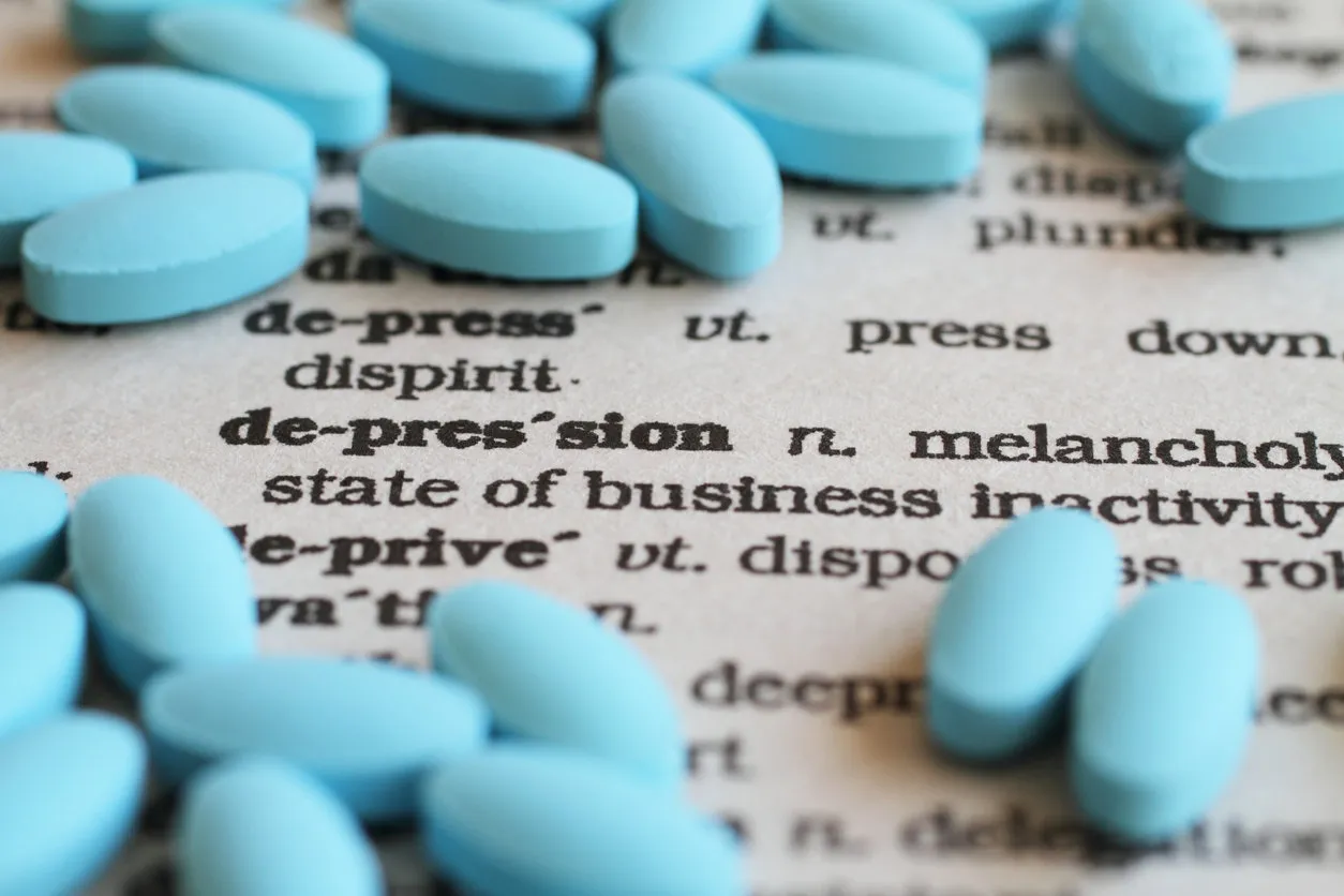 a close up image of the word depression surrounded by pills a close up image of the word depression surrounded by pills