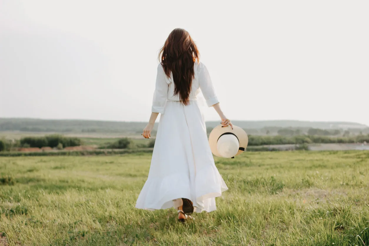 beautiful carefree long hair asian girl in white clothes and straw hat enjoys life in nature field at sunset sensitivity to nature concept beautiful carefree long hair asian girl in white clothes and straw hat enjoys life in nature field at sunset sensitivity to nature concept