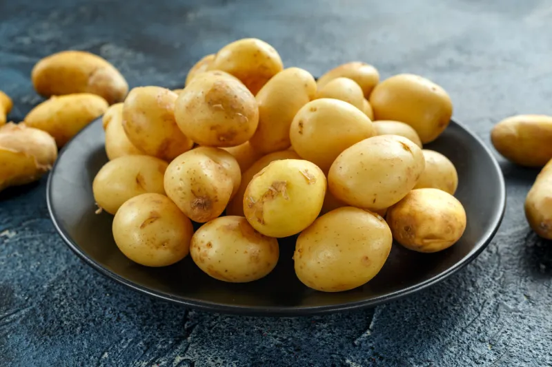 raw baby new potatoes in black plate raw baby new potatoes in black plate