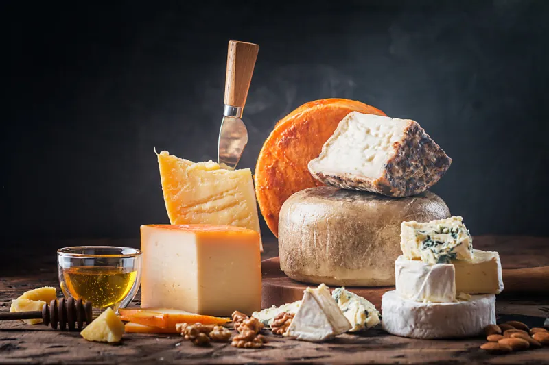 various types of cheese on rustic wooden table various types of cheese on rustic wooden table