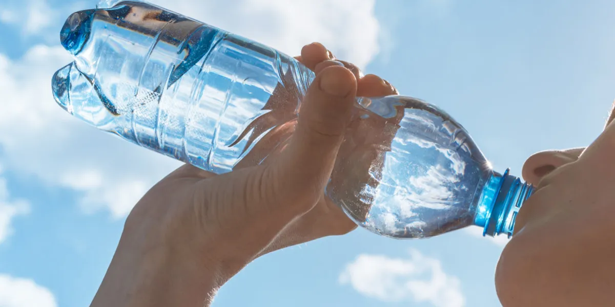 woman drinking water after her workout woman drinking water after her workout