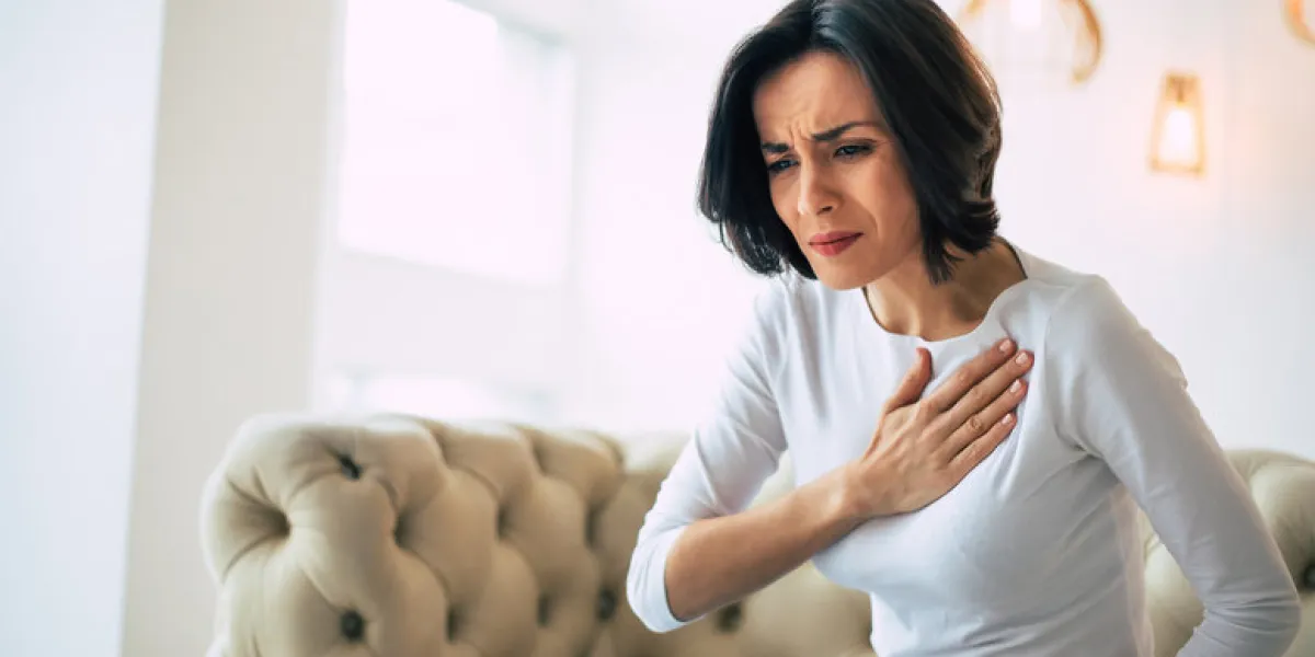 pressure in the chest close-up photo of a stressed woman who is suffering from a chest pain and touching her heart area pressure in the chest close-up photo of a stressed woman who is suffering from a chest pain and touching her heart area
