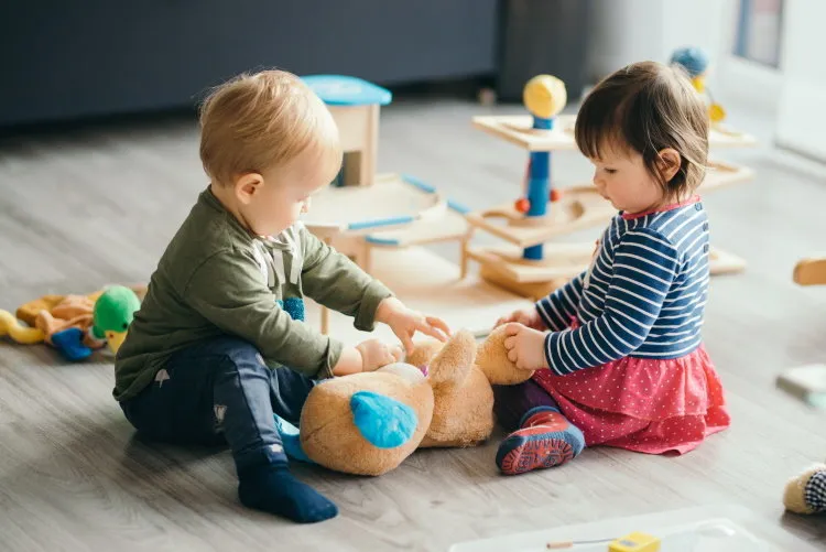 cute little girl and boy playing with toys by the home cute little girl and boy playing with toys by the home