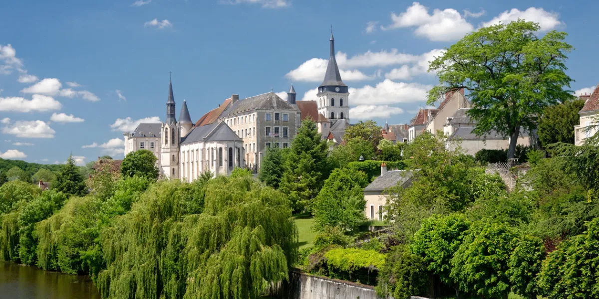 the french village of saint gaultier and its church surrounded with trees, stand on the banks of the creuse river by a sunny springtime day the french village of saint gaultier and its church surrounded with trees, stand on the banks of the creuse river by a sunny springtime day
