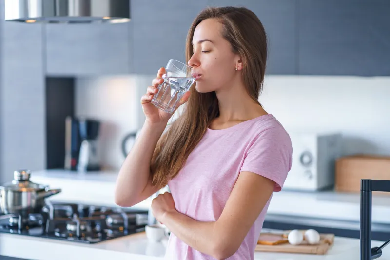 happy attractive joyful brunette woman drinking fresh clean filtered purified water at kitchen at home healthy lifestyle and quench thirst happy attractive joyful brunette woman drinking fresh clean filtered purified water at kitchen at home healthy lifestyle and quench thirst