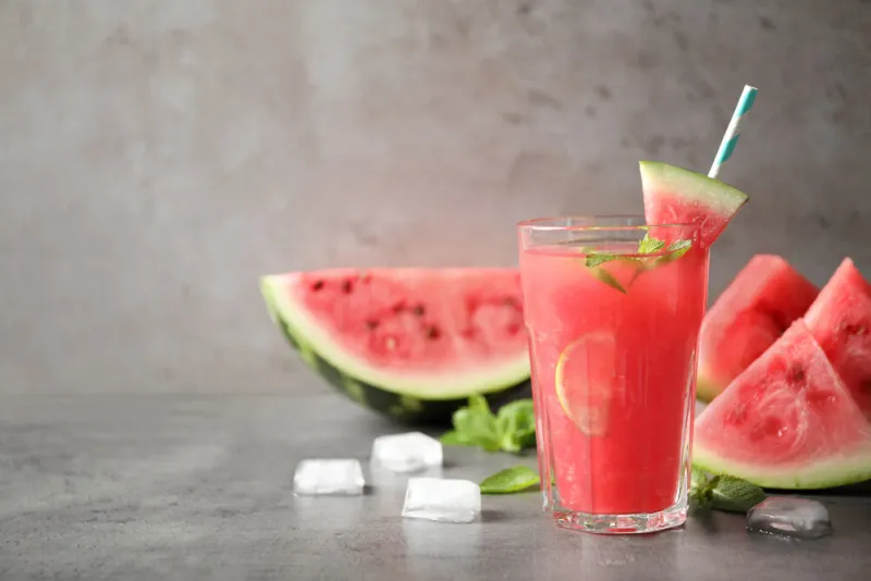 glass of tasty refreshing drink with watermelon on grey table space for text glass of tasty refreshing drink with watermelon on grey table space for text