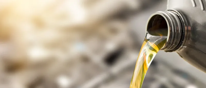 pouring oil to car engine fresh oil poured during an oil change to a car pouring oil to car engine fresh oil poured during an oil change to a car