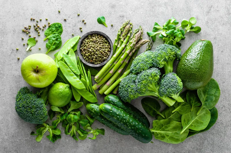 healthy vegetarian food concept background, fresh green food selection for detox diet, raw broccoli, apple, cucumber, spinach, peas, asparagus, avocado, lime, corn salad and mung bean, view from above, flat lay healthy vegetarian food concept background, fresh green food selection for detox diet, raw broccoli, apple, cucumber, spinach, peas, asparagus, avocado, lime, corn salad and mung bean, view from above, flat lay