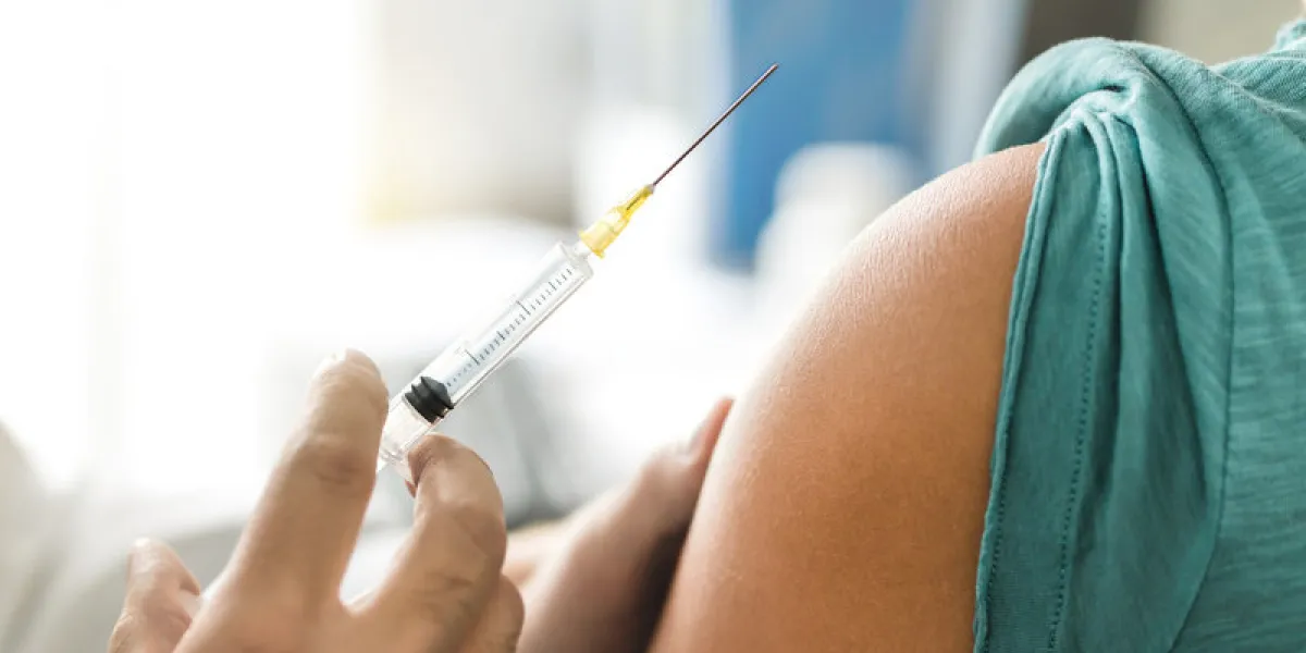 vaccine or flu shot in injection needle doctor working with patient's arm physician or nurse giving vaccination and immunity to virus, influenza or hpv with syringe appointment with medical expert
