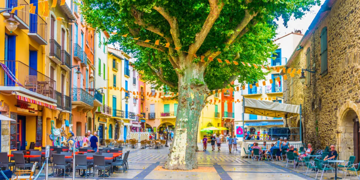 collioure, france, june 27, 2017  people are strolling through a narrow street in the center of collioure, france