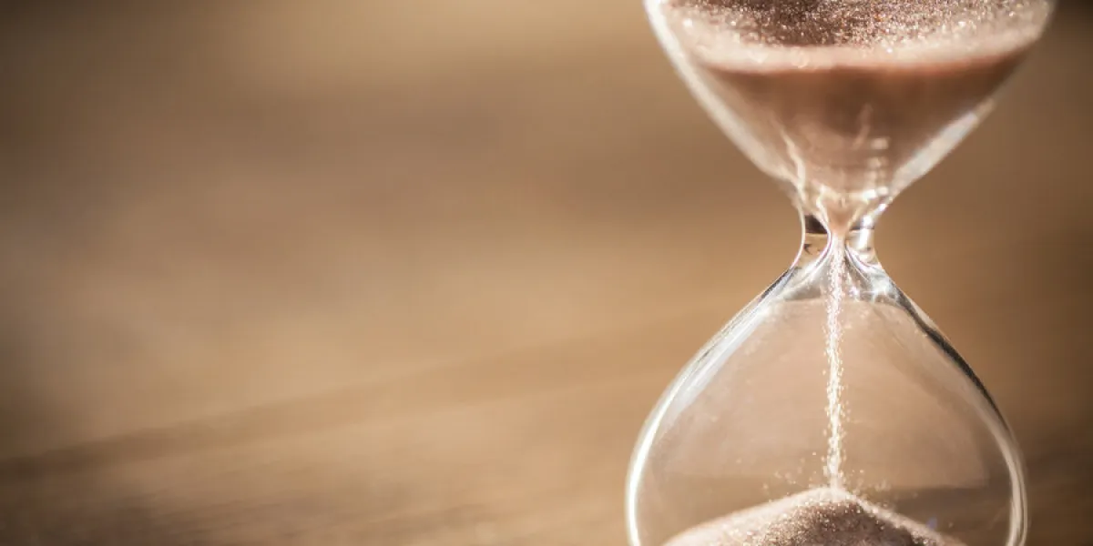 sand running through the bulbs of an hourglass measuring the pas sand running through the bulbs of an hourglass measuring the pas