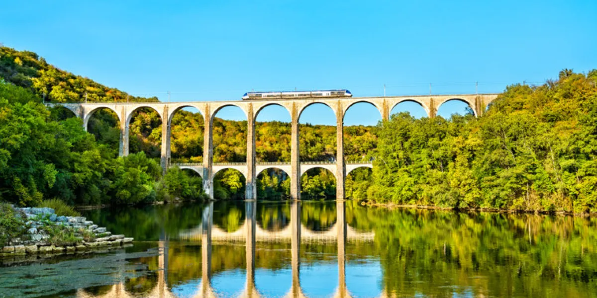 regional train on the cize-bolozon viaduct across the ain gorge in france