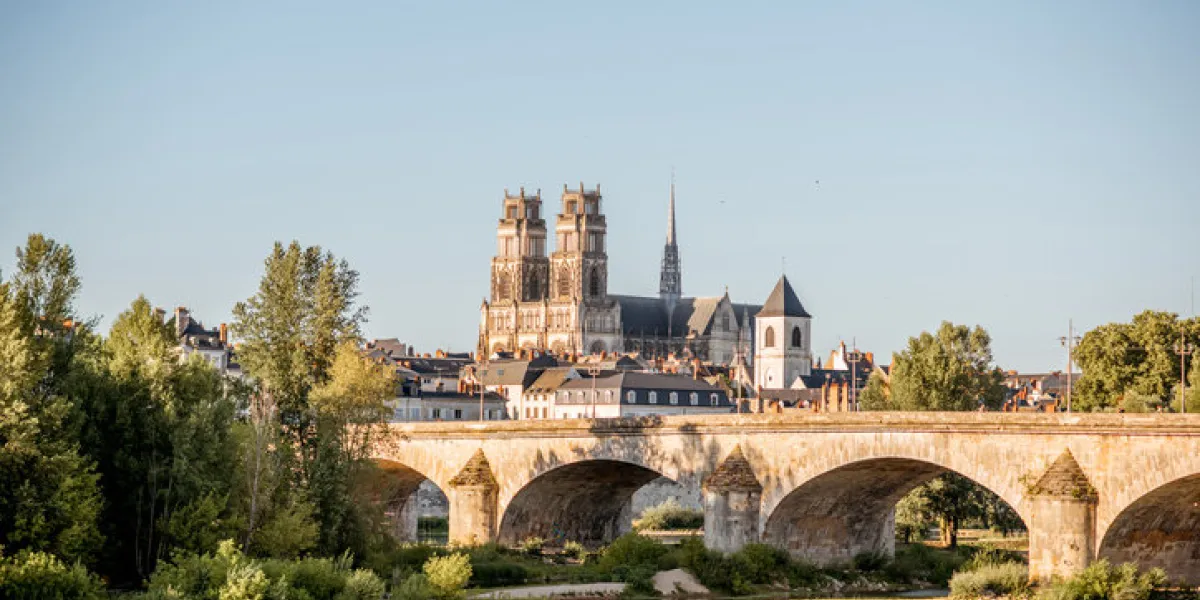 landscape view on the river and old arch bridge in orleans city during the sunset in france landscape view on the river and old arch bridge in orleans city during the sunset in france