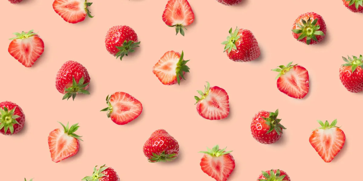 colorful pattern of strawberries on pink background top view colorful pattern of strawberries on pink background top view