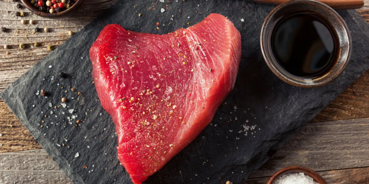 raw organic pink tuna steak with salt and pepper raw organic pink tuna steak with salt and pepper