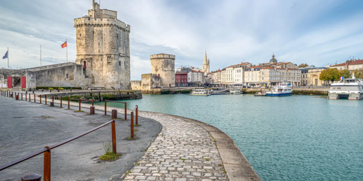 cobbled pathway leading to fortified medieval towers at the vieux port (old port) at la rochelle, charente maritime, poitou charentes, on the atlantic coast of france