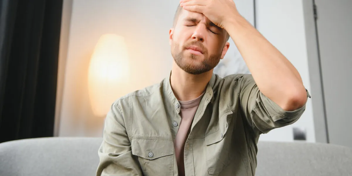 closeup of middle-aged bearded man suffering from headache at home, touching his temples, panorama with copy space migraine, headache, stress, tension problem, hangover concept closeup of middle-aged bearded man suffering from headache at home, touching his temples, panorama with copy space migraine, headache, stress, tension problem, hangover concept