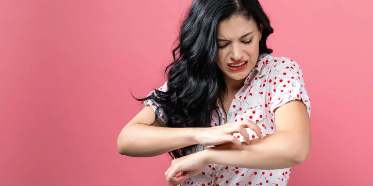 young woman scratching her itchy arm skin problem young woman scratching her itchy arm skin problem