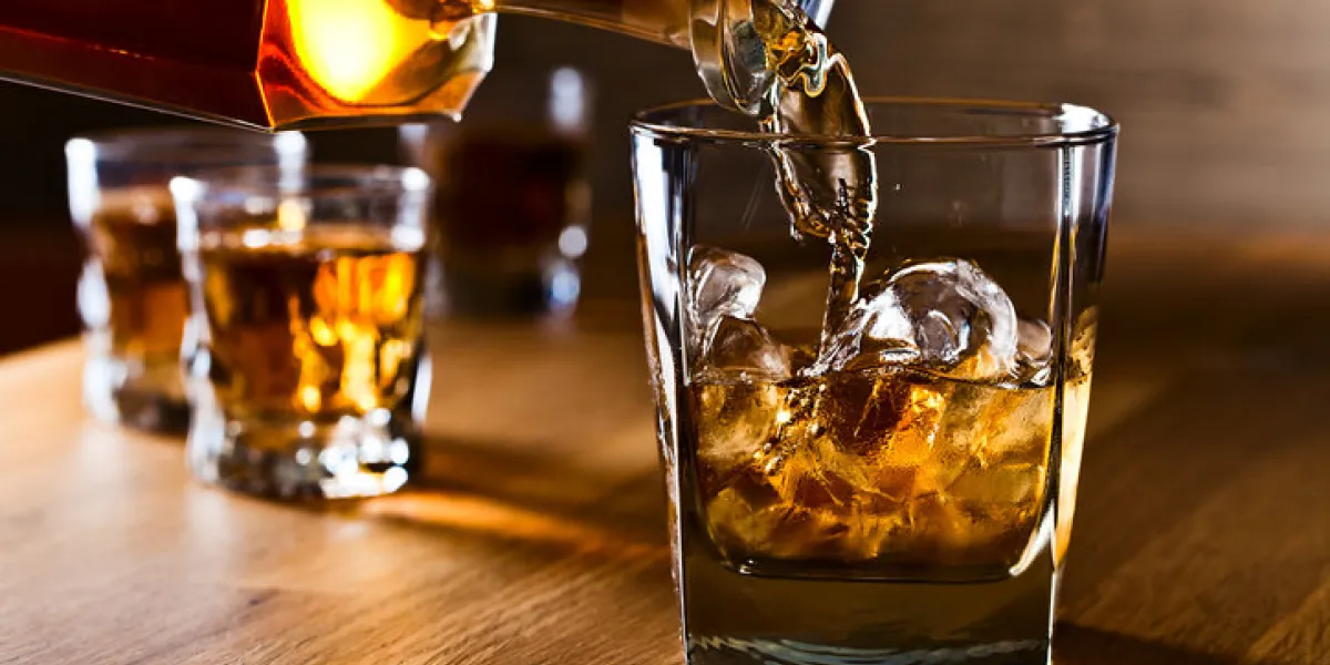 whiskey and natural ice on old wooden table