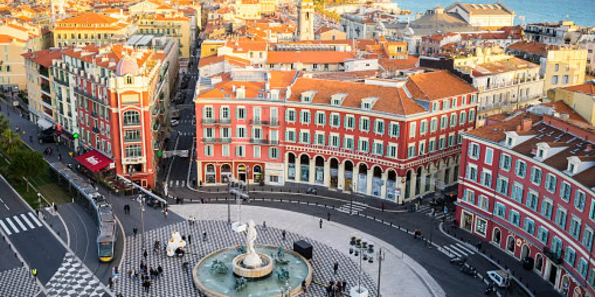 an aerial view of the fontaine du soleil in place messena, nice with the new tram track and buildings of nice and the sea in the background an aerial view of the fontaine du soleil in place messena, nice with the new tram track and buildings of nice and the sea in the background