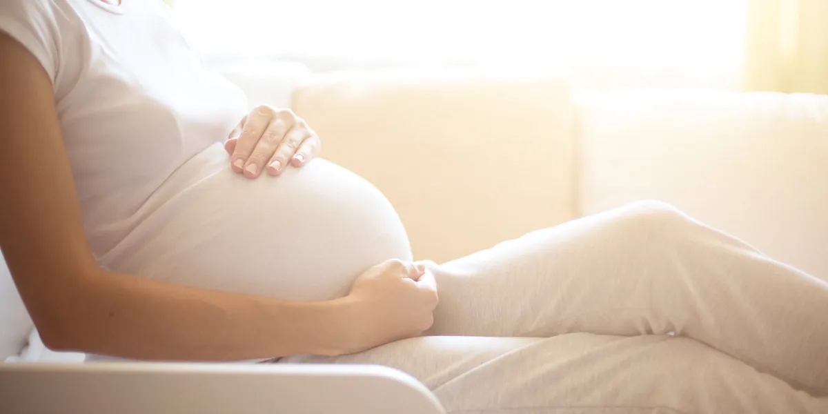 pregnancy happy pregnant woman lying in bed and touching her belly at home pregnancy happy pregnant woman lying in bed and touching her belly at home