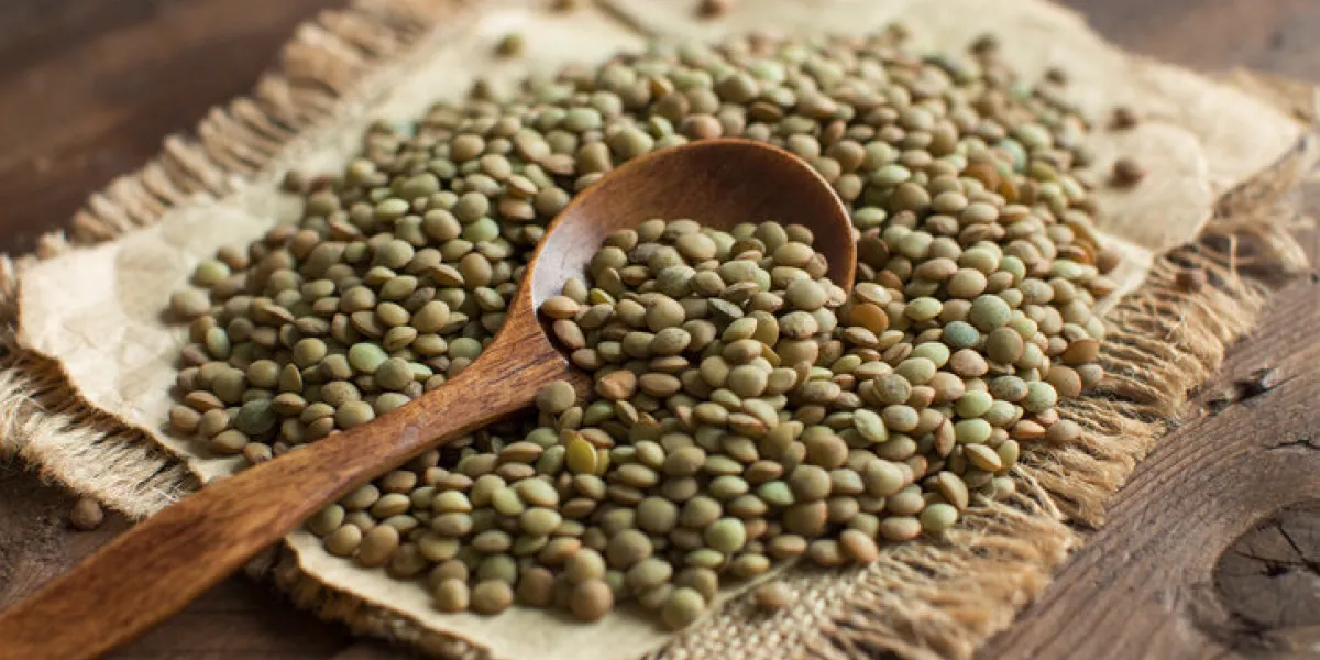 green lentils with a spoon on a wooden table top view green lentils with a spoon on a wooden table top view
