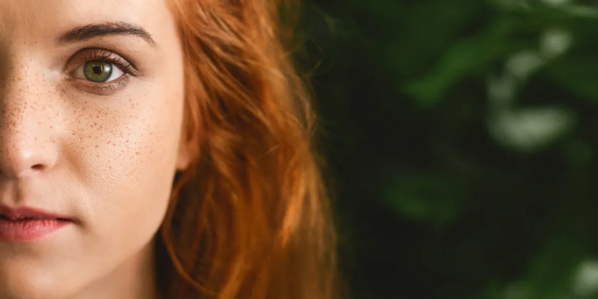 natural cosmetics and skincare beautiful redhead woman on green leaves background, panorama with copy space natural cosmetics and skincare beautiful redhead woman on green leaves background, panorama with copy space