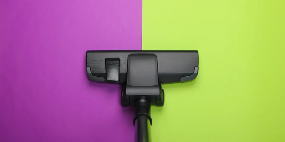 vacuum cleaner brush on green purple background top view cleaning concept vacuum cleaner brush on green purple background top view cleaning concept