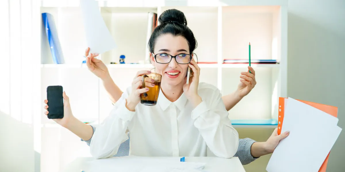 a successful businesswoman is multitasking in office