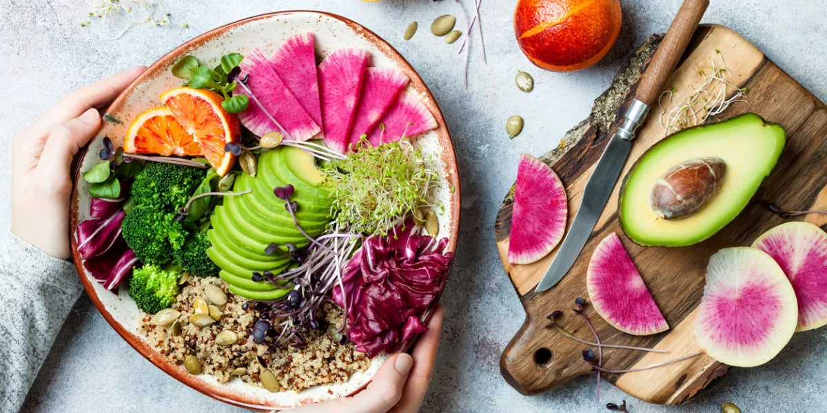 girl holding vegan, detox buddha bowl with quinoa, micro greens, avocado, blood orange, broccoli, watermelon radish, alfalfa seed sprouts girl holding vegan, detox buddha bowl with quinoa, micro greens, avocado, blood orange, broccoli, watermelon radish, alfalfa seed sprouts