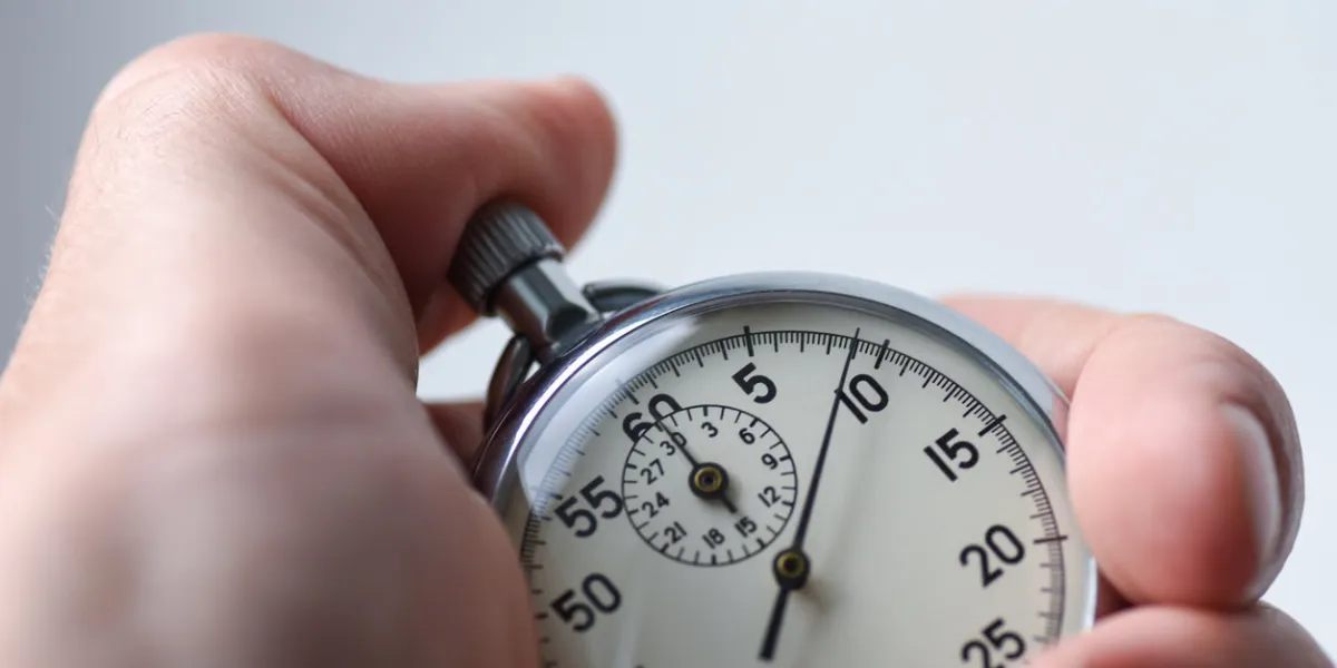 a close-up of an isolated hand presses the stopwatch start button in the sport, measurements, metrology